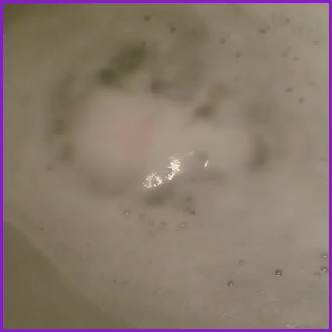 Romance Goat Milk Bath Bomb Soak spinning and foaming in a tub of water from share the soap dot com